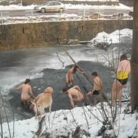Голые нудисты купаются зимой в реке