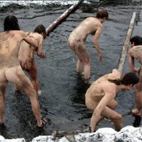 Голые нудисты купаются зимой в реке